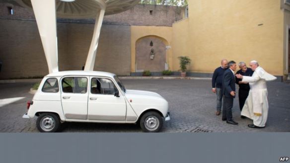 Pope Francis, right, and Father Renzo Zocca, second right, with the Renault 4. Photograph: AP